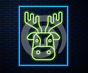 Glowing neon line Deer head with antlers icon isolated on brick wall background. Vector