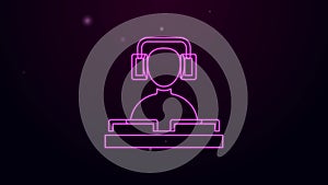 Glowing neon line DJ wearing headphones in front of record decks icon isolated on black background. DJ playing music. 4K