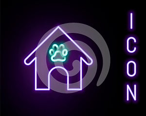 Glowing neon line Dog house and paw print pet icon isolated on black background. Dog kennel. Colorful outline concept