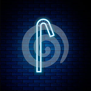 Glowing neon line Drinking plastic straw icon isolated on brick wall background. Colorful outline concept. Vector