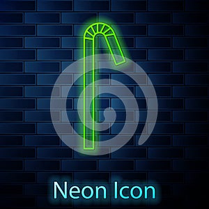 Glowing neon line Drinking plastic straw icon isolated on brick wall background. Vector Illustration