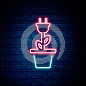 Glowing neon line Electric saving plug in pot icon isolated on brick wall background. Save energy electricity icon