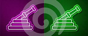 Glowing neon line Fire hose reel icon isolated on purple and green background. Vector