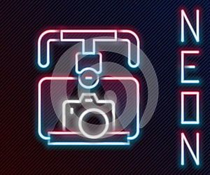 Glowing neon line Gimbal stabilizer with DSLR camera icon isolated on black background. Colorful outline concept. Vector