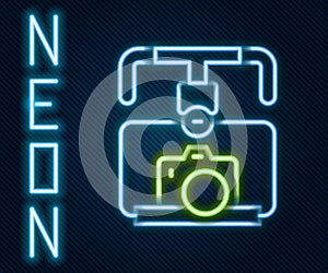 Glowing neon line Gimbal stabilizer with DSLR camera icon isolated on black background. Colorful outline concept. Vector