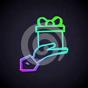 Glowing neon line Give gift icon isolated on black background. Gift in hand. The concept of giving and receiving a gift