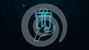 Glowing neon line Give gift icon isolated on black background. Gift in hand. The concept of giving and receiving a gift