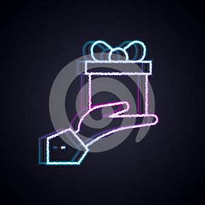 Glowing neon line Give gift icon isolated on black background. Gift in hand. The concept of giving and receiving a gift