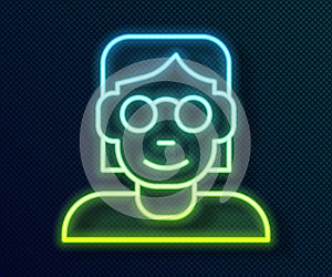 Glowing neon line Hacker or coder icon isolated on black background. Programmer developer working on code, coding