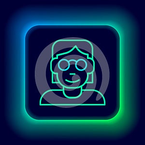 Glowing neon line Hacker or coder icon isolated on black background. Programmer developer working on code, coding