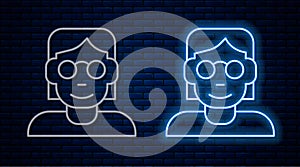 Glowing neon line Hacker or coder icon isolated on brick wall background. Programmer developer working on code, coding