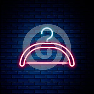 Glowing neon line Hanger wardrobe icon isolated on brick wall background. Cloakroom icon. Clothes service symbol