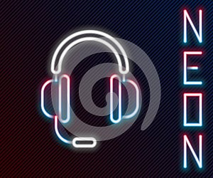 Glowing neon line Headphones with microphone icon isolated on black background. Colorful outline concept. Vector