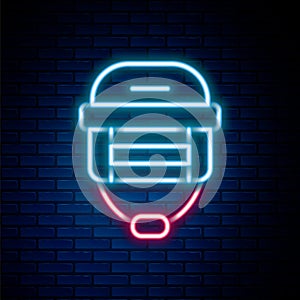 Glowing neon line Hockey helmet icon isolated on brick wall background. Colorful outline concept. Vector