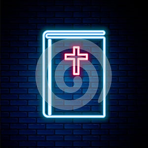 Glowing neon line Holy bible book icon isolated on brick wall background. Colorful outline concept. Vector