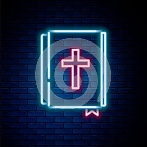 Glowing neon line Holy bible book icon isolated on brick wall background. Colorful outline concept. Vector