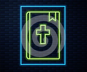 Glowing neon line Holy bible book icon isolated on brick wall background. Vector