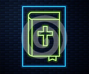 Glowing neon line Holy bible book icon isolated on brick wall background. Vector