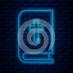 Glowing neon line Holy bible book icon isolated on brick wall background. Vector Illustration