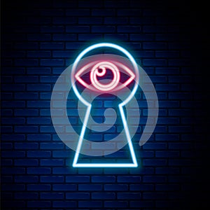 Glowing neon line Keyhole with eye icon isolated on brick wall background. The eye looks into the keyhole. Keyhole eye