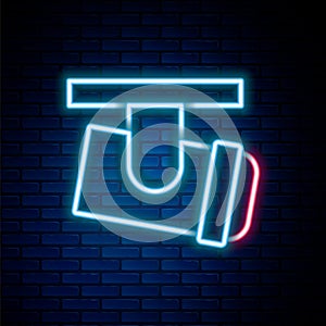 Glowing neon line Led track lights and lamps with spotlights icon isolated on brick wall background. Colorful outline