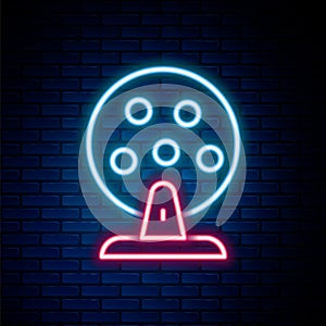 Glowing neon line Lottery machine with lottery balls inside icon isolated on brick wall background. Lotto bingo game of