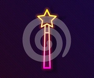 Glowing neon line Magic wand icon isolated on black background. Star shape magic accessory. Magical power. Vector