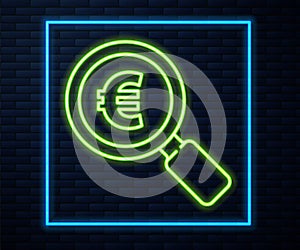 Glowing neon line Magnifying glass and euro symbol icon isolated on brick wall background. Find money. Looking for money