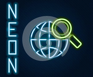 Glowing neon line Magnifying glass with globe icon isolated on black background. Analyzing the world. Global search sign