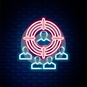 Glowing neon line Marketing target strategy concept icon isolated on brick wall background. Aim with people sign