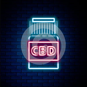 Glowing neon line Medical bottle with marijuana or cannabis leaf icon isolated on brick wall background. Mock up of