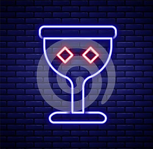 Glowing neon line Medieval goblet icon isolated on brick wall background. Holy grail. Colorful outline concept. Vector