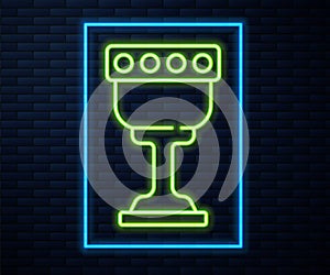 Glowing neon line Medieval goblet icon isolated on brick wall background. Holy grail. Vector