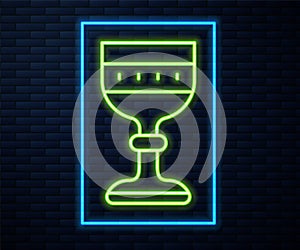 Glowing neon line Medieval goblet icon isolated on brick wall background. Vector