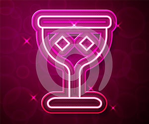 Glowing neon line Medieval goblet icon isolated on red background. Holy grail. Vector