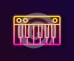 Glowing neon line Music synthesizer icon isolated on black background. Electronic piano. Vector Illustration.