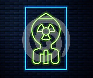 Glowing neon line Nuclear bomb icon isolated on brick wall background. Rocket bomb flies down. Vector