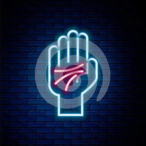 Glowing neon line Palmistry of the hand icon isolated on brick wall background. Colorful outline concept. Vector