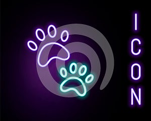 Glowing neon line Paw print icon isolated on black background. Dog or cat paw print. Animal track. Colorful outline