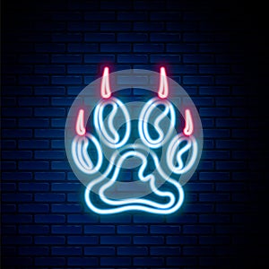 Glowing neon line Paw print icon isolated on brick wall background. Dog or cat paw print. Animal track. Colorful outline