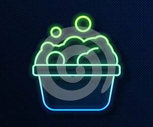 Glowing neon line Pets bath icon isolated on blue background. Vector