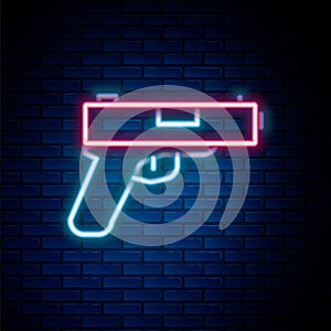 Glowing neon line Pistol or gun icon isolated on brick wall background. Police or military handgun. Small firearm