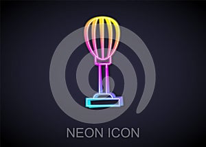 Glowing neon line Punching bag icon isolated on black background. Vector