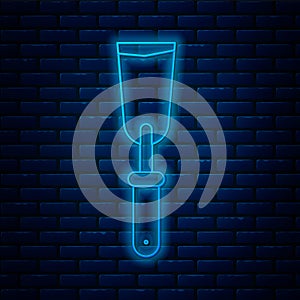 Glowing neon line Putty knife icon isolated on brick wall background. Spatula repair tool. Spackling or paint