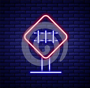 Glowing neon line Railroad crossing icon isolated on brick wall background. Railway sign. Colorful outline concept