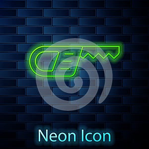 Glowing neon line Reciprocating saw and saw blade icon isolated on brick wall background. Vector