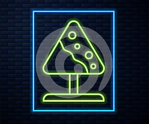 Glowing neon line Road sign avalanches icon isolated on brick wall background. Snowslide or snowslip rapid flow of snow