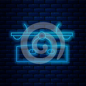 Glowing neon line Seesaw icon isolated on brick wall background. Teeter equal board. Playground symbol. Vector