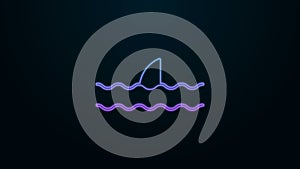 Glowing neon line Shark fin in ocean wave icon isolated on black background. 4K Video motion graphic animation