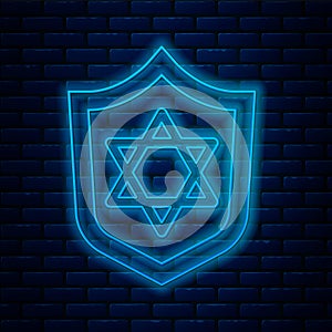 Glowing neon line Shield with Star of David icon isolated on brick wall background. Jewish religion symbol. Symbol of